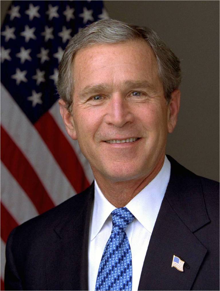 A picture of george w. Bush in front of an american flag