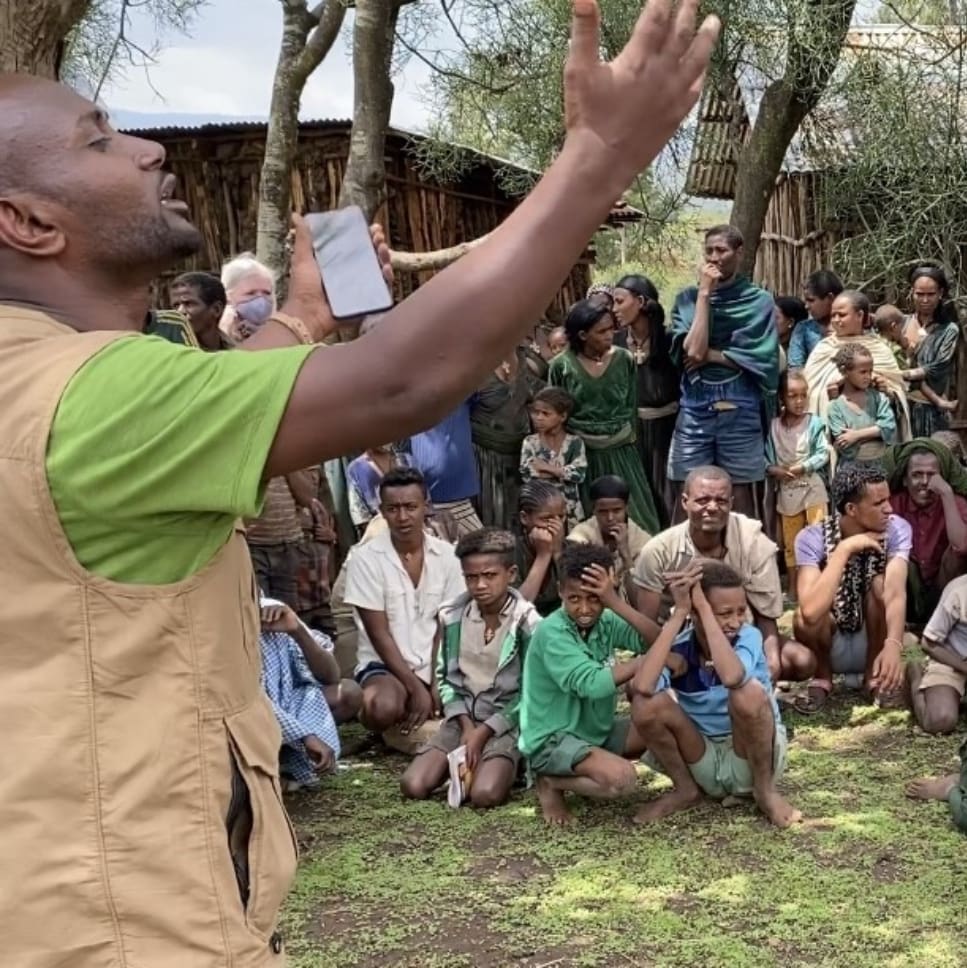 A man is singing in front of a crowd.