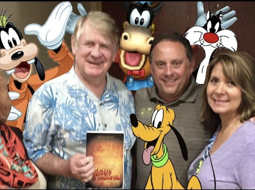 A group of people posing for the camera with cartoon characters.